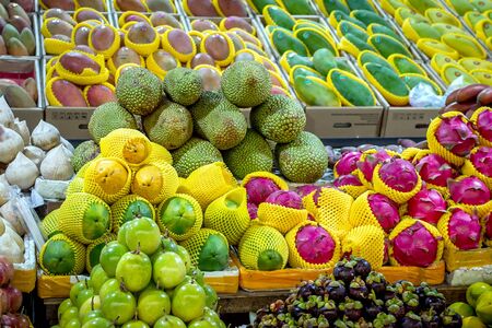 Fresh tropical fruits are on the market window. Healthy, organic food. Banana, pineapple, ananas, durian, Dragon fruit, coconut, mango, mangosteen, rambutanの写真素材