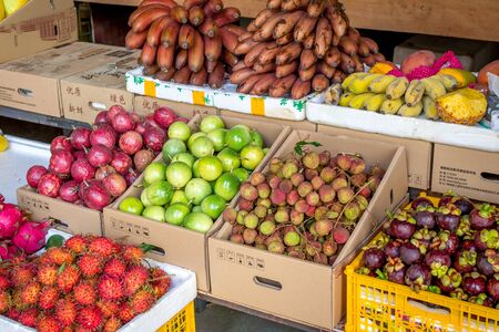 Sanya, Hainan, China - May 18, 2019: Typical Asian fruit market. Fresh tropical fruits are on the market window. Healthy, organic foodのeditorial素材