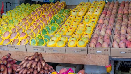 Sanya, Hainan, China - May 18, 2019: Typical Asian fruit market. Fresh tropical fruits are on the market window. Healthy, organic foodのeditorial素材
