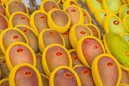Sanya, Hainan, China - May 18, 2019: Typical Asian fruit market. Fresh tropical fruits are on the market window. Healthy, organic foodのeditorial素材