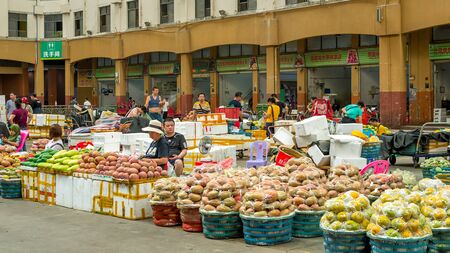 Sanya, Hainan, China - May 18, 2019: Typical Asian fruit market. Fresh tropical fruits are on the market window. Healthy, organic foodのeditorial素材