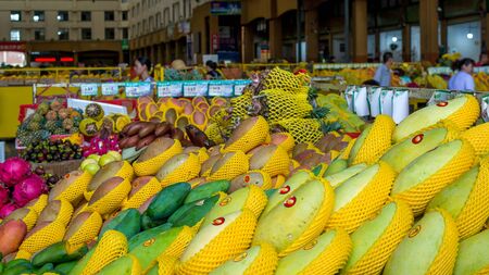 Sanya, Hainan, China - May 18, 2019: Typical Asian fruit market. Fresh tropical fruits are on the market window. Healthy, organic foodのeditorial素材