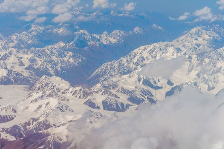 View from the illuminator of the plane to Zailiyskiy Alatau, a mountain range in the northwest of Tien Shanの写真素材