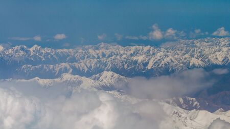 View from the illuminator of the plane to Zailiyskiy Alatau, a mountain range in the northwest of Tien Shanの写真素材