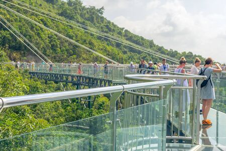 Blur. China. The mountains are covered with impassable tropical forests, jungles. Hainan island, Forest Park Yanoda. Observation deck in the form of a glass bridge at an altitude of more than 200 m.のeditorial素材