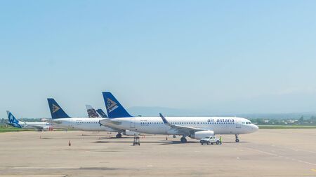 Almaty, Kazakhstan - May 10, 2019: View from the airfield of Almaty on the Zailiyskiy Alatau. Parked Airbus A320 of the largest Kazakhstani air carrier AIR ASTANA.のeditorial素材