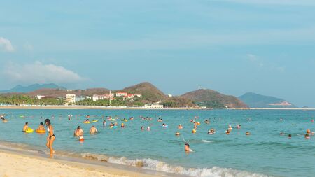 Hainan, China - May 14, 2019: On a bright sunny day on a tropical beach, people swim in the sea, relax on the sandのeditorial素材