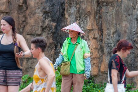 Haikou, Hainan, China - May 12, 2019: Service staff in the Hainan Tropical Wildlife Parc and Botanical Garden. Chinese woman in uniform, working clothes rangersのeditorial素材