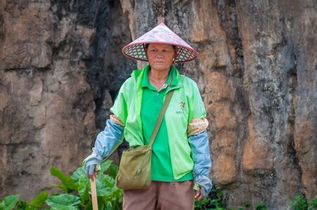 Haikou, Hainan, China - May 12, 2019: Service staff in the Hainan Tropical Wildlife Parc and Botanical Garden. Chinese woman in uniform, working clothes rangersのeditorial素材