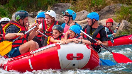 Myhia, Ukraine - August 17, 2019: Rafting. A cheerful group of men and women descends on a large inflatable boat on the river. There is a child in the boat. Sincere emotions of happy people.のeditorial素材