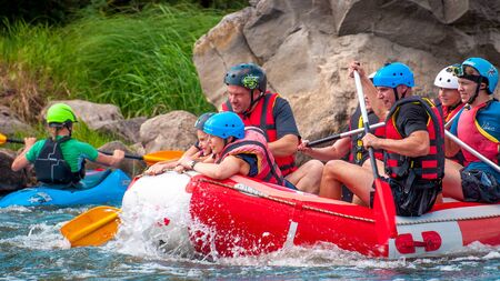 Myhia, Ukraine - August 17, 2019: Rafting. A cheerful group of men and women descends on a large inflatable boat on the river. There is a child in the boat. Sincere emotions of happy people.のeditorial素材
