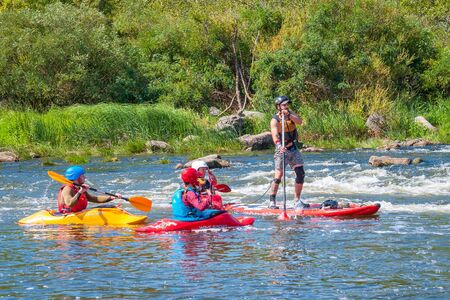 Myhiya, Ukraine - August 17, 2019: Athletes kayakers during training on whitewater. Man on...