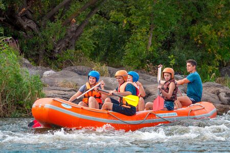 Myhia, Ukraine - August 17, 2019: Rafting. A cheerful group of men and women descends on a large inflatable boat on the river. Sincere emotions of happy people.のeditorial素材