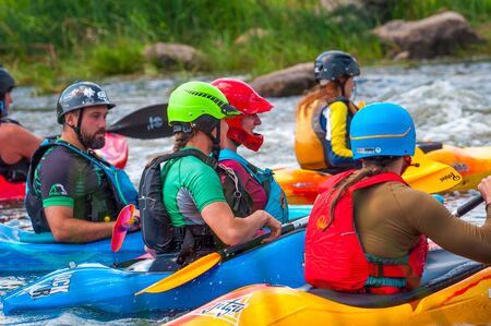 Myhiya, Ukraine - August 17, 2019: Playboating. A company of young freestyle kayakers. A short break during a workout on whitewater.のeditorial素材