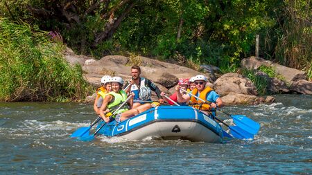 Myhia, Ukraine - August 17, 2019: Rafting. A cheerful group of men and women descends on a large inflatable boat on the river. Sincere emotions of happy people.のeditorial素材