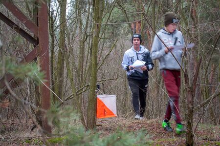 Katerynka, Ukraine - December 13, 2019: Orienteering. Traditional annual game. Young athletes marks the passage of the control pointのeditorial素材