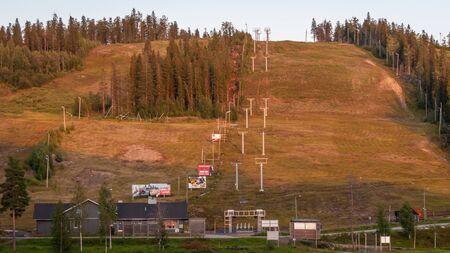Finland - August 19, 2018. Ukkohalla Ski Resort. The most environmentally friendly air. A lake in the middle of a forest. Cozy picturesque cottages. View of the ski slopes in summerのeditorial素材