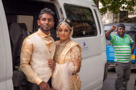 Galle, Sri Lanka - May 28, 2016: Bride and groom near the car. Behind the curtains of a wedding photo shoot of Sri Lankan couples. Backstage photo session love storyのeditorial素材
