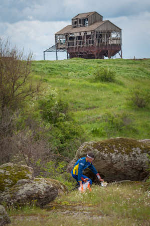 Village of Aktovo, Ukraine - May 21, 2021: Orienteering race. Traditional annual orienteering game Partisan Spark Cup 2021. Athlete marks the passage of the control pointのeditorial素材