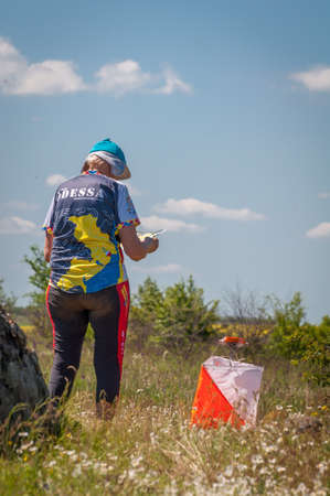 Village Aktovo, Ukraine - May 21, 2021: Orienteering race. Traditional annual game. Athlete during orienteering, checkpointのeditorial素材