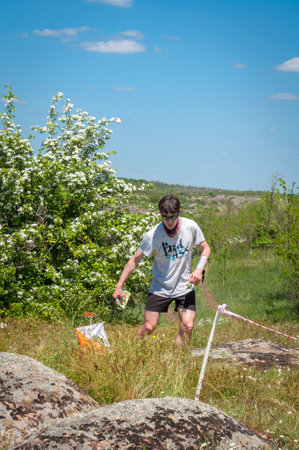 Village Aktovo, Ukraine - May 21, 2021: Orienteering race. Traditional annual game. Athlete during orienteering, checkpointのeditorial素材