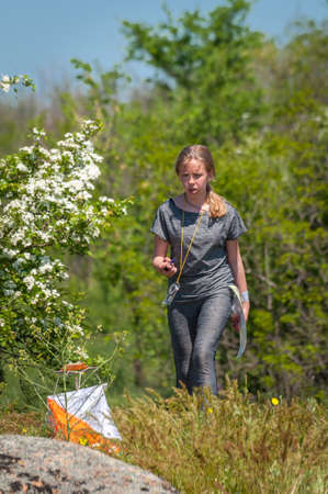 Village Aktovo, Ukraine - May 21, 2021: Orienteering race. Traditional annual game. Athlete during orienteering, checkpointのeditorial素材