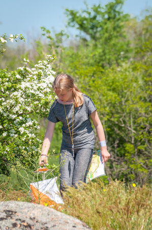 Village Aktovo, Ukraine - May 21, 2021: Orienteering race. Traditional annual game. Athlete during orienteering, checkpointのeditorial素材