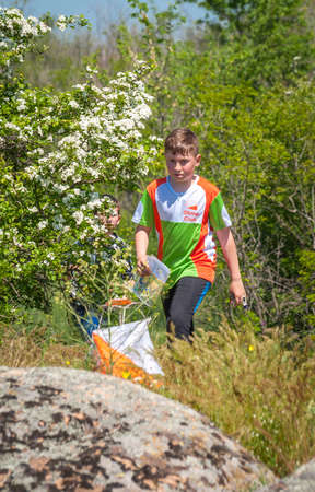 Village Aktovo, Ukraine - May 21, 2021: Orienteering race. Traditional annual game. Athlete during orienteering, checkpointのeditorial素材