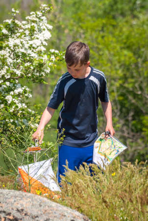 Village Aktovo, Ukraine - May 21, 2021: Orienteering race. Traditional annual game. Athlete during orienteering, checkpointのeditorial素材