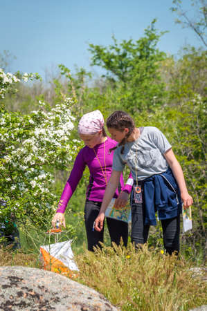 Village Aktovo, Ukraine - May 21, 2021: Orienteering race. Traditional annual game. Athlete during orienteering, checkpointのeditorial素材