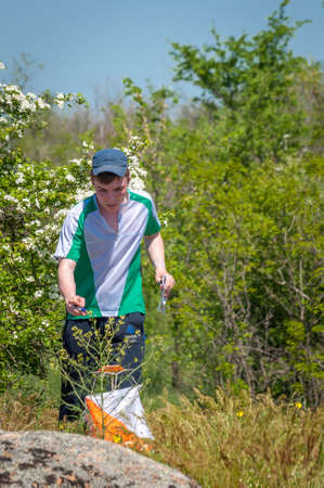 Village Aktovo, Ukraine - May 21, 2021: Orienteering race. Traditional annual game. Athlete during orienteering, checkpointのeditorial素材