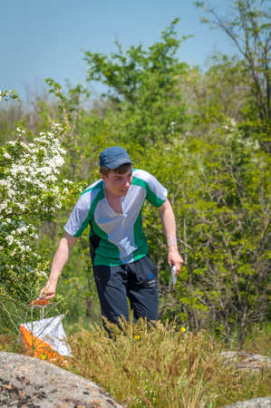 Village Aktovo, Ukraine - May 21, 2021: Orienteering race. Traditional annual game. Athlete during orienteering, checkpointのeditorial素材