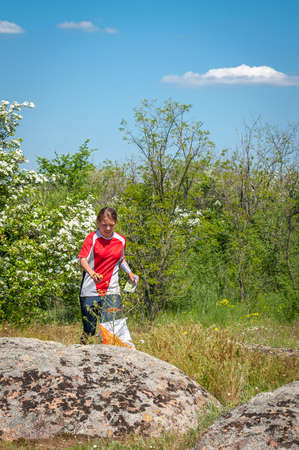 Village Aktovo, Ukraine - May 21, 2021: Orienteering race. Traditional annual game. Athlete during orienteering, checkpointのeditorial素材