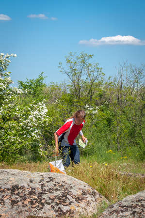 Village Aktovo, Ukraine - May 21, 2021: Orienteering race. Traditional annual game. Athlete during orienteering, checkpointのeditorial素材