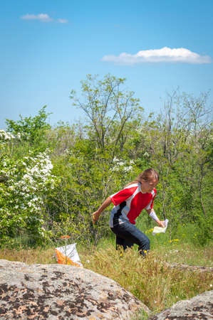 Village Aktovo, Ukraine - May 21, 2021: Orienteering race. Traditional annual game. Athlete during orienteering, checkpointのeditorial素材