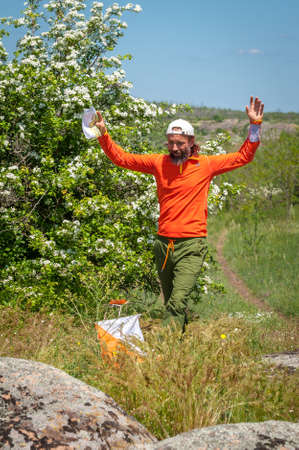 Village Aktovo, Ukraine - May 21, 2021: Orienteering race. Traditional annual game. Athlete during orienteering, checkpointのeditorial素材