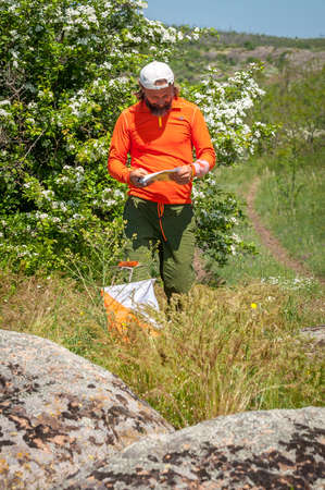 Village Aktovo, Ukraine - May 21, 2021: Orienteering race. Traditional annual game. Athlete during orienteering, checkpointのeditorial素材