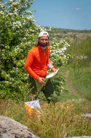 Village Aktovo, Ukraine - May 21, 2021: Orienteering race. Traditional annual game. Athlete during orienteering, checkpointのeditorial素材