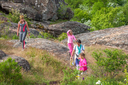 Village Aktovo, Ukraine - May 21, 2021: Orienteering race. Traditional annual game Partisan Spark Cup 2021. An adult athlete and a group of children-athletes on the route of orienteering.のeditorial素材