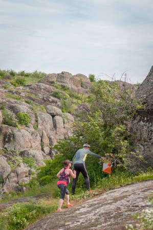 Village Aktovo, Ukraine - May 21, 2021: Orienteering race. Traditional annual game. Athlete during orienteering, checkpointのeditorial素材
