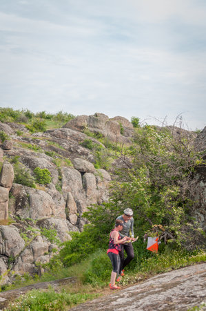 Village Aktovo, Ukraine - May 21, 2021: Orienteering race. Traditional annual game. Athlete during orienteering, checkpointのeditorial素材