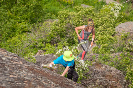 Village Aktovo, Ukraine - May 21, 2021: Orienteering race. Traditional annual game. Athlete during orienteering trail. Young athletes helping each other overcome the difficult part of the routeのeditorial素材