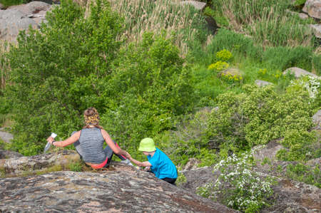 Village Aktovo, Ukraine - May 21, 2021: Orienteering race. Traditional annual game. Athlete during orienteering trail. Young athletes helping each other overcome the difficult part of the routeのeditorial素材