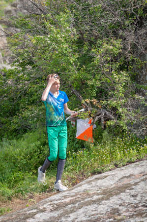 Village Aktovo, Ukraine - May 21, 2021: Orienteering race. Traditional annual game. Athlete during orienteering, checkpointのeditorial素材