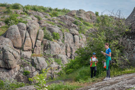 Village Aktovo, Ukraine - May 21, 2021: Orienteering race. Traditional annual game. Athlete during orienteering, checkpointのeditorial素材