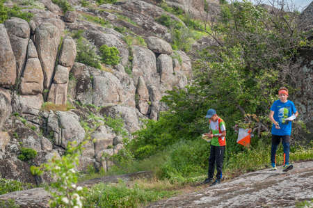 Village Aktovo, Ukraine - May 21, 2021: Orienteering race. Traditional annual game. Athlete during orienteering, checkpointのeditorial素材