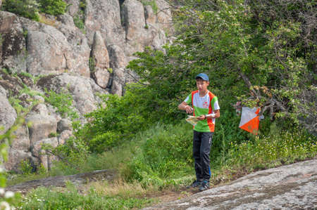 Village Aktovo, Ukraine - May 21, 2021: Orienteering race. Traditional annual game. Athlete during orienteering, checkpointのeditorial素材