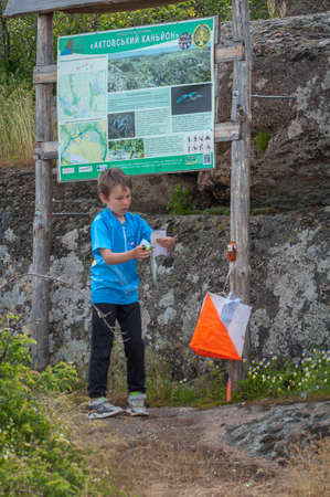 Village Aktovo, Ukraine - May 21, 2021: Orienteering race. Traditional annual game. Athlete during orienteering, checkpointのeditorial素材
