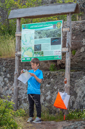 Village Aktovo, Ukraine - May 21, 2021: Orienteering race. Traditional annual game. Athlete during orienteering, checkpointのeditorial素材