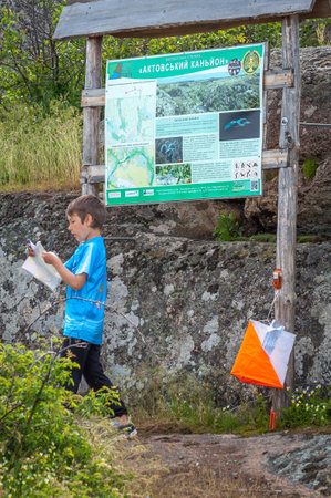 Village Aktovo, Ukraine - May 21, 2021: Orienteering race. Traditional annual game. Athlete during orienteering, checkpointのeditorial素材